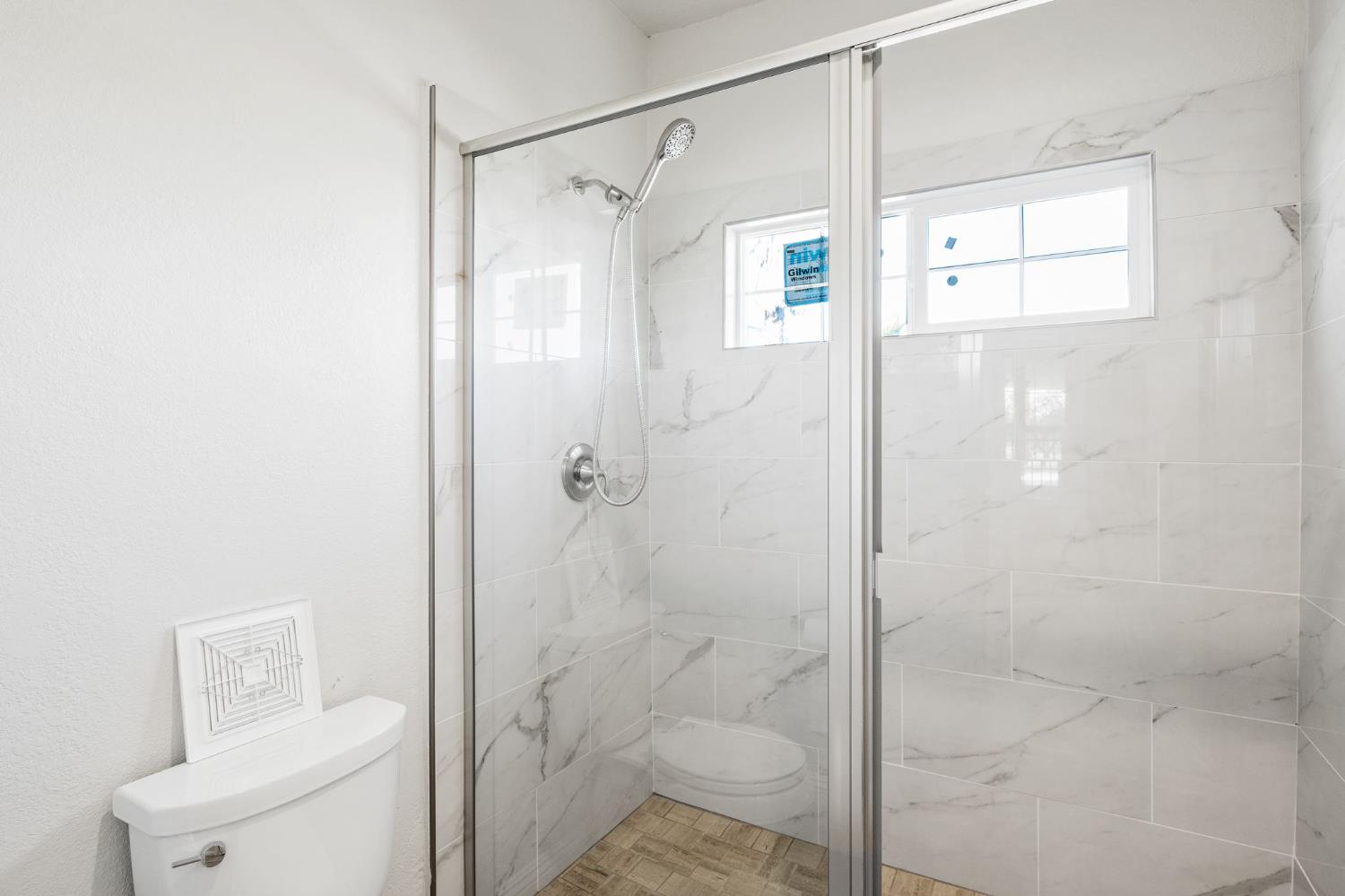 6312 Skittone Road Modesto, CA 95356 - Photo 35 of 93 a bathroom with a shower and toilet