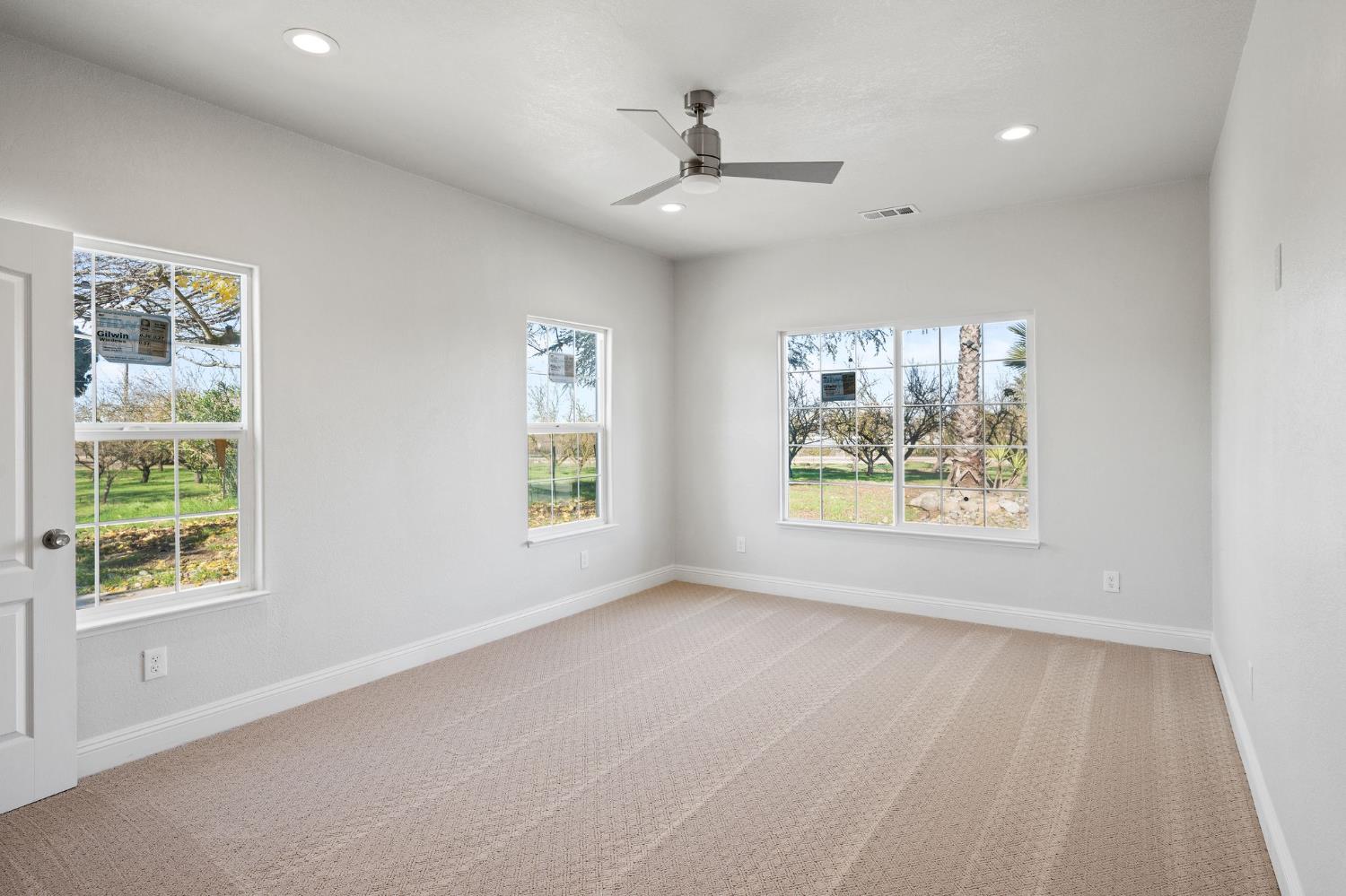 6312 Skittone Road Modesto, CA 95356 - Photo 36 of 93 a view of an empty room with a window and wooden floor