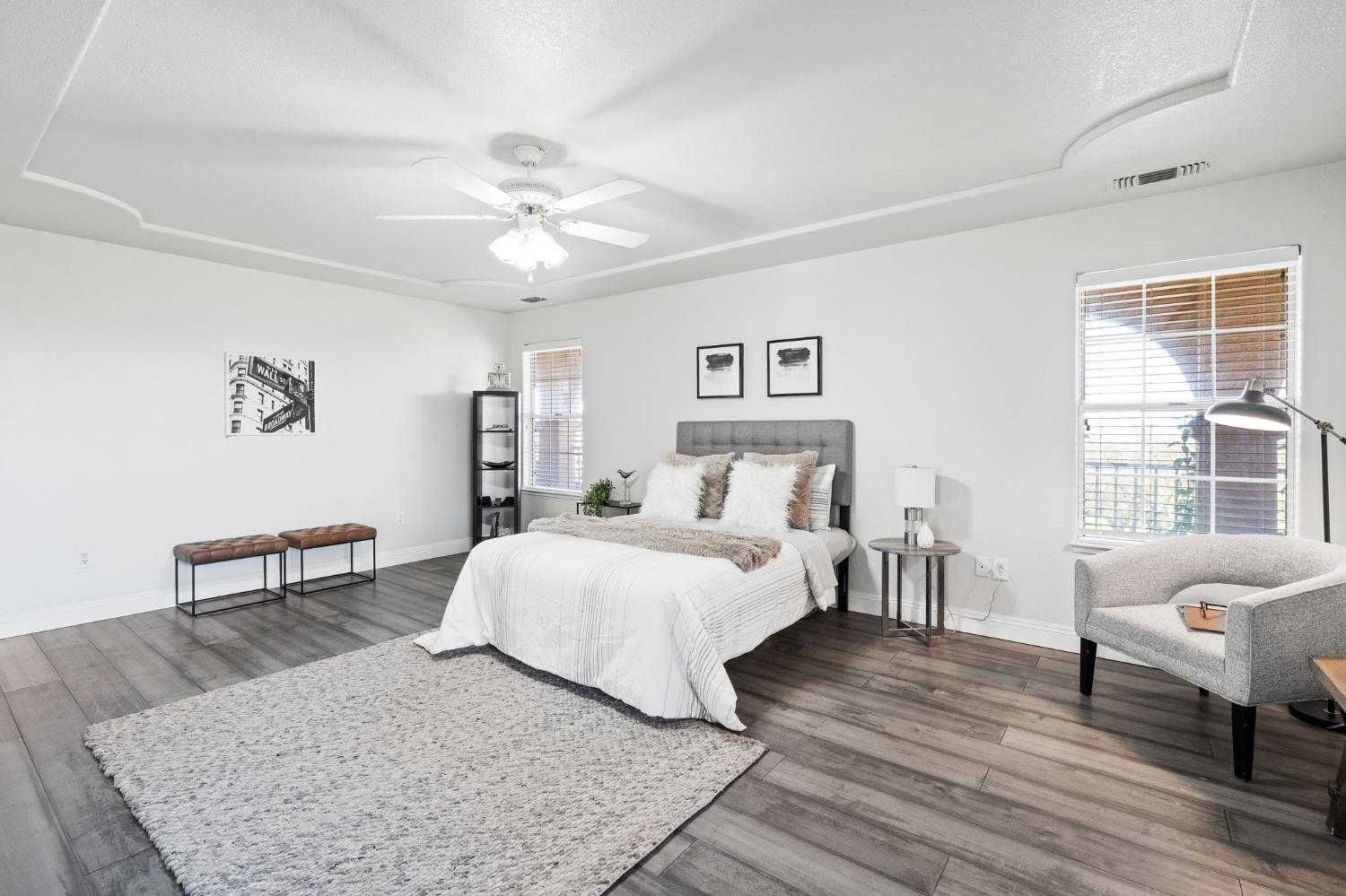 6312 Skittone Road Modesto, CA 95356 - Photo 49 of 93 a bedroom with a bed a couch and a dresser with wooden floor