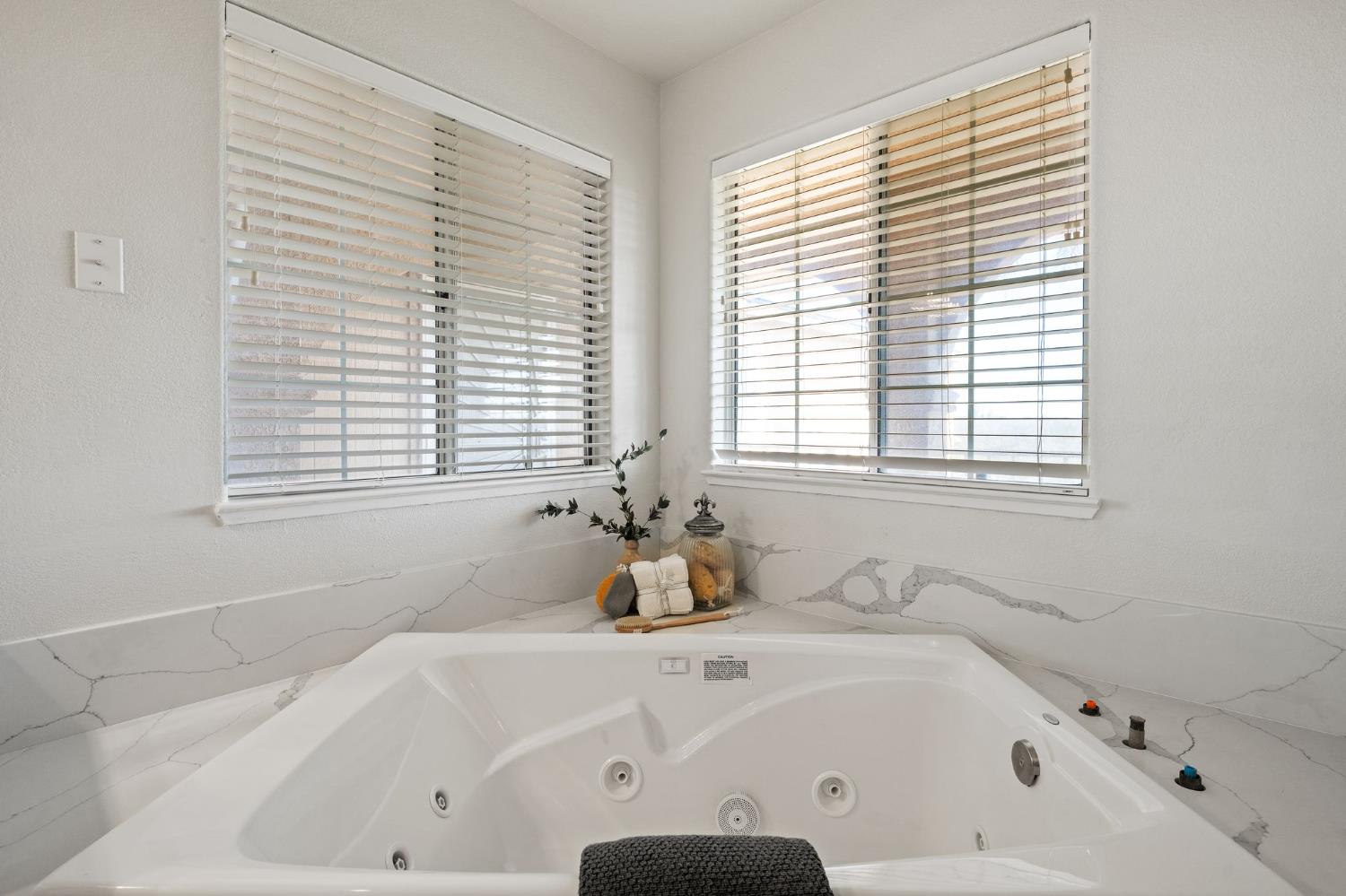 6312 Skittone Road Modesto, CA 95356 - Photo 51 of 93 a white bath tub sitting in a bathroom next to a window
