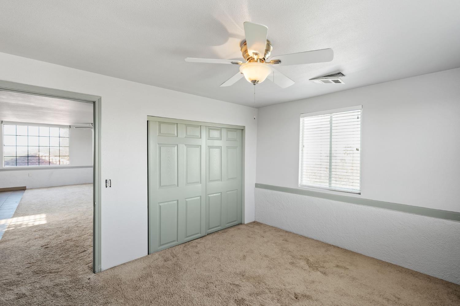 6312 Skittone Road Modesto, CA 95356 - Photo 71 of 93 an empty room with windows and fan