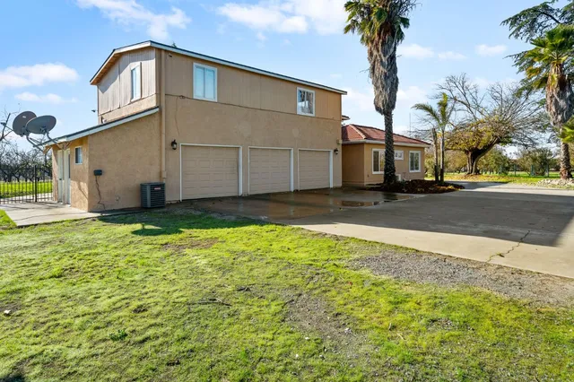 a living room with furniture a fireplace and a large window