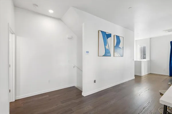 a view of entryway with stairs and wooden floor