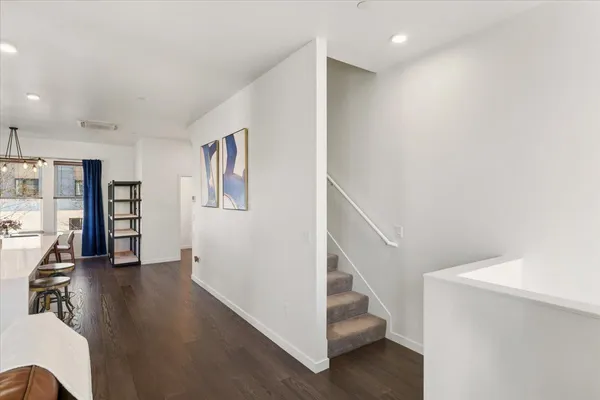a view of a hallway with white walls