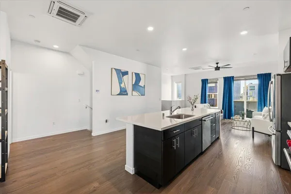 a kitchen with a stove and wooden floor