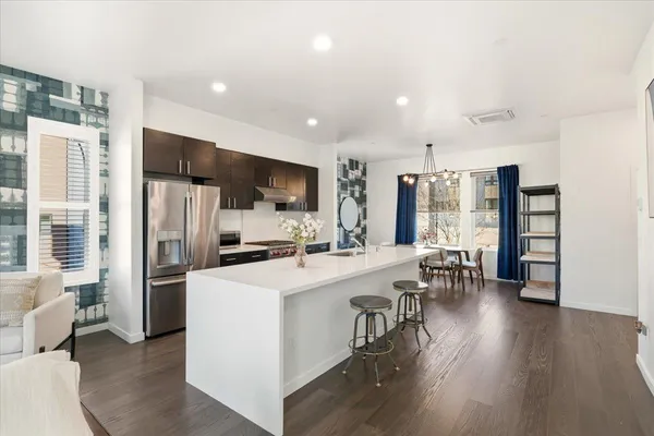 a kitchen with a sink a counter top stainless steel appliances and cabinets