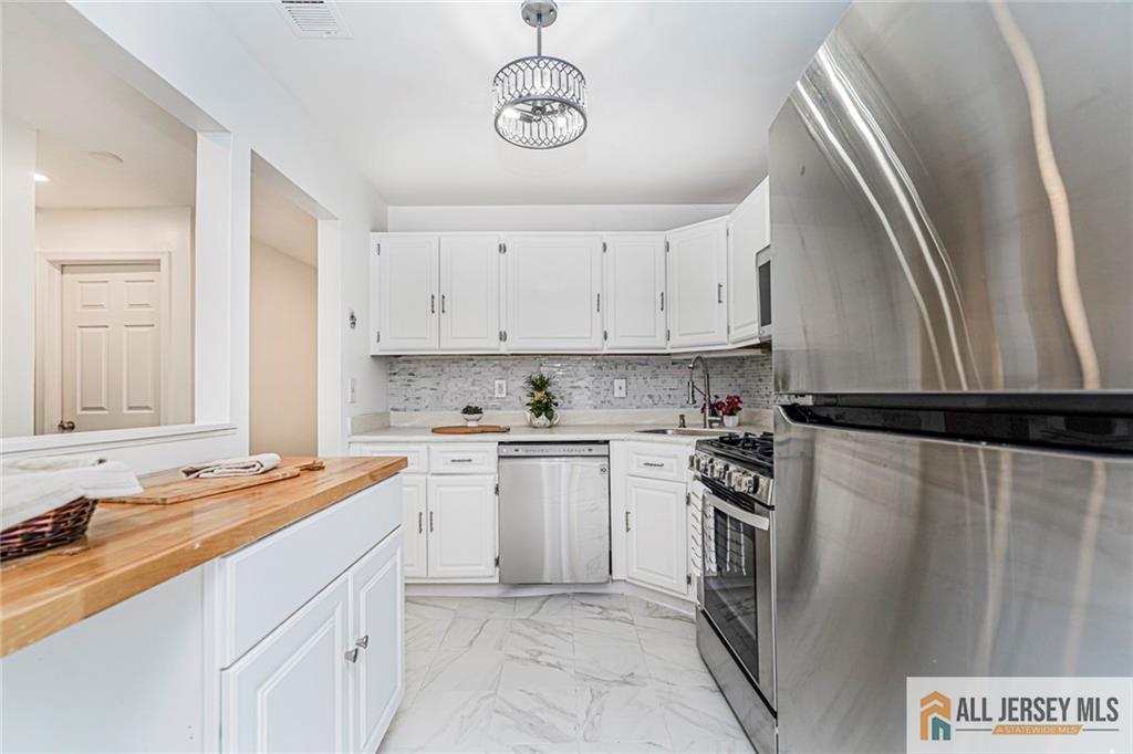 612 Chester Court Helmetta, NJ 08828 - Photo 10 of 31 a kitchen with stainless steel appliances granite countertop a sink stove and refrigerator