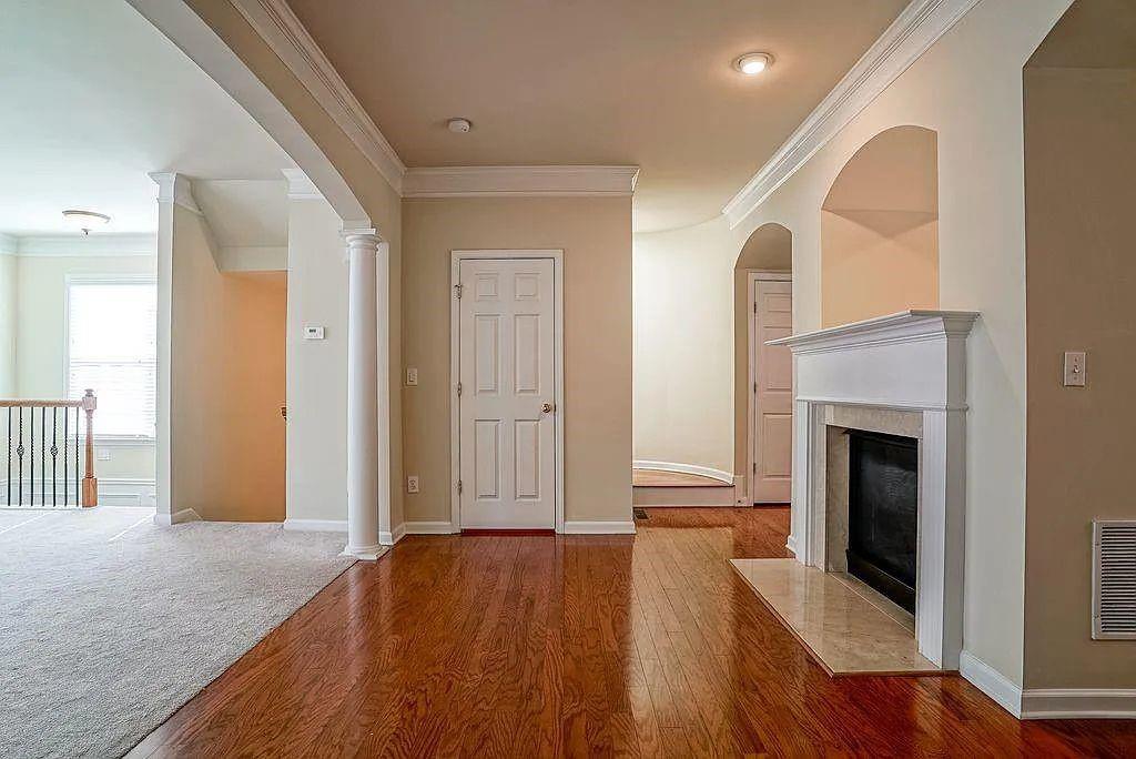 6120 Joybrook Road Duluth, GA 30097 - Photo 7 of 30 a view of a livingroom with wooden floor and a fireplace