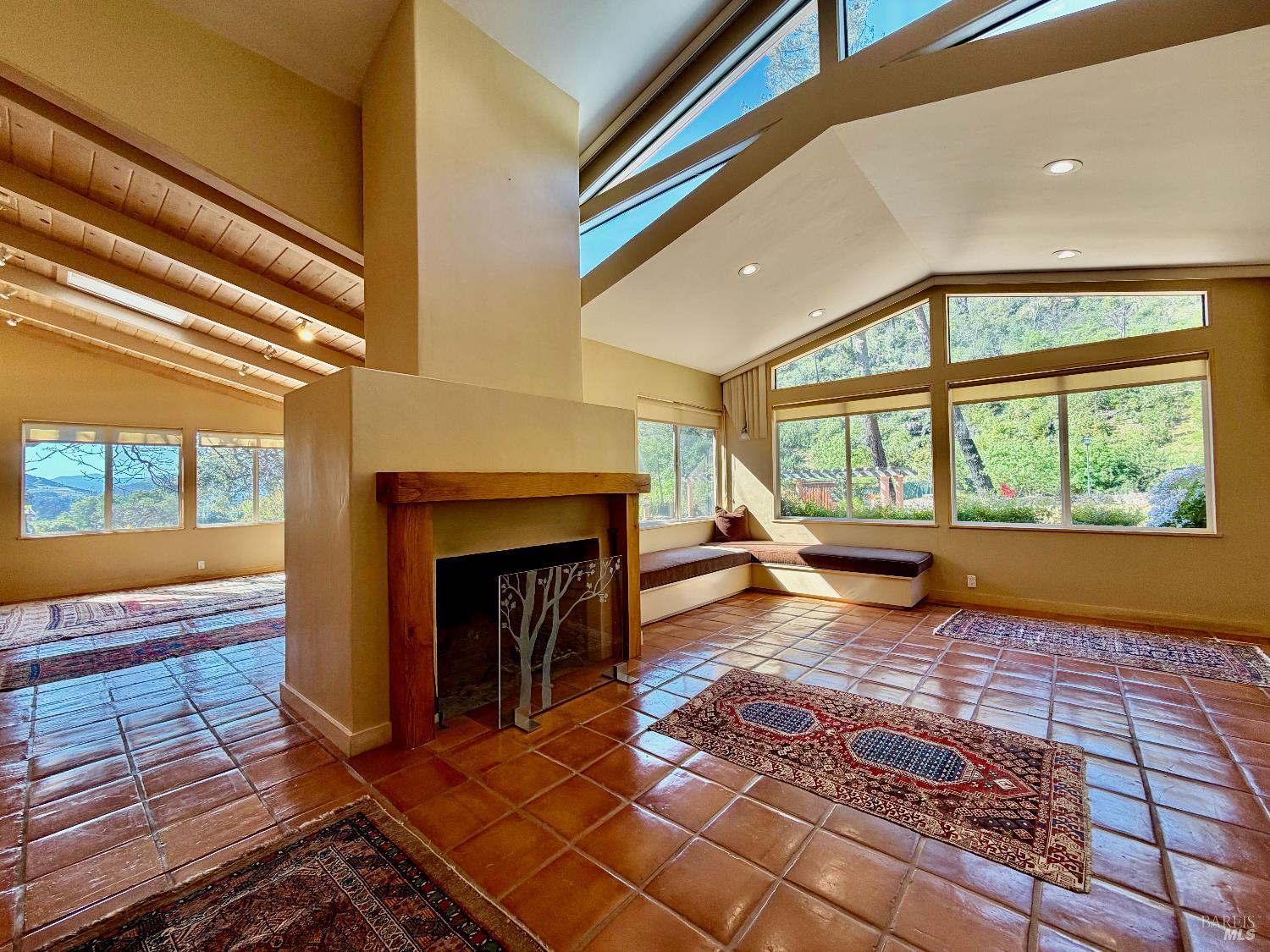321 Dutch Henry Canyon Road Calistoga, CA 94515 - Photo 7 of 50 a view of an empty room with wooden floor fireplace and windows