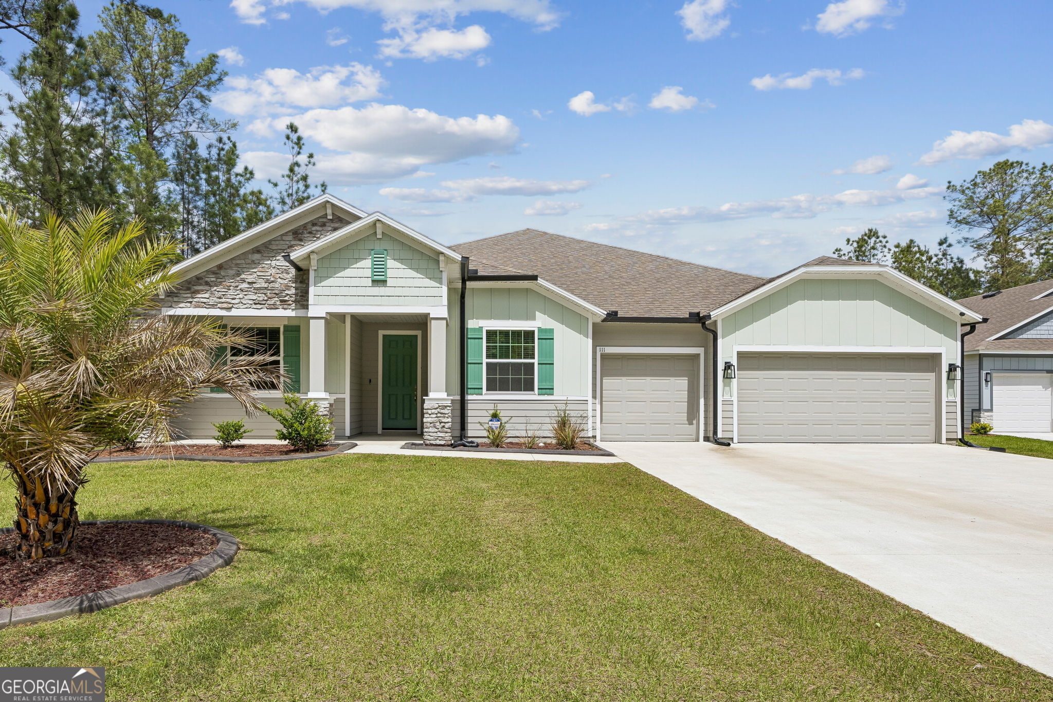 a front view of a house with yard and green space