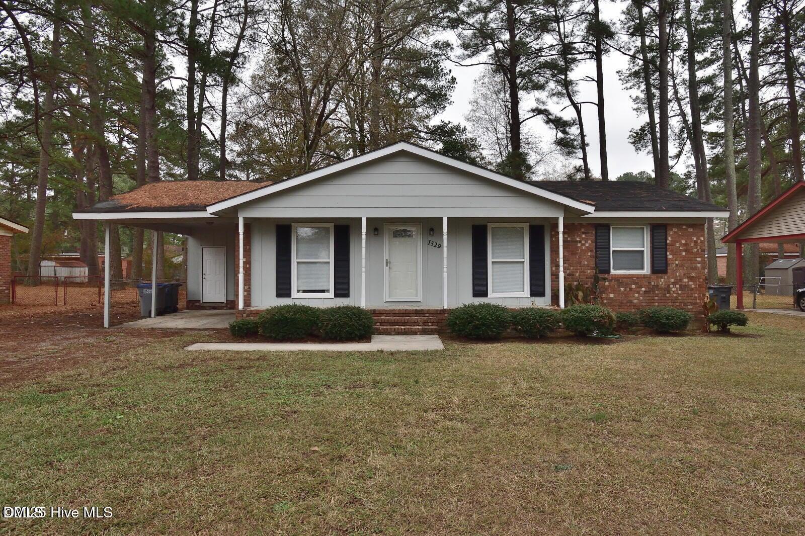a front view of a house with yard and green space