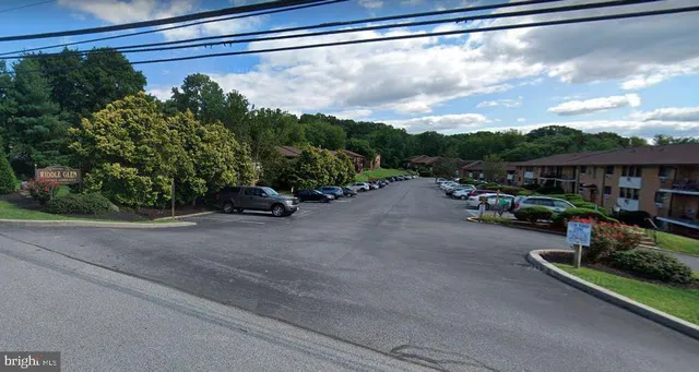 a view of a street with cars parked