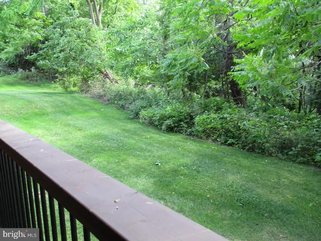 a view of a yard with a wooden fence