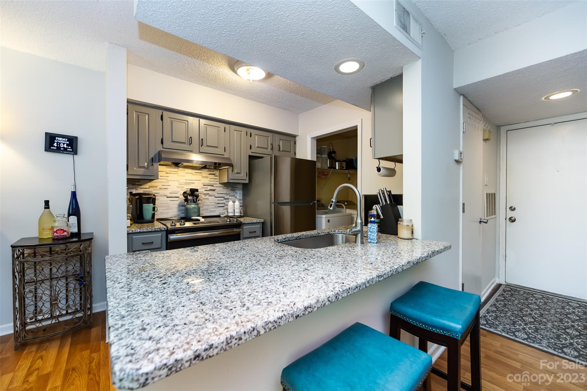 a kitchen with sink and refrigerator
