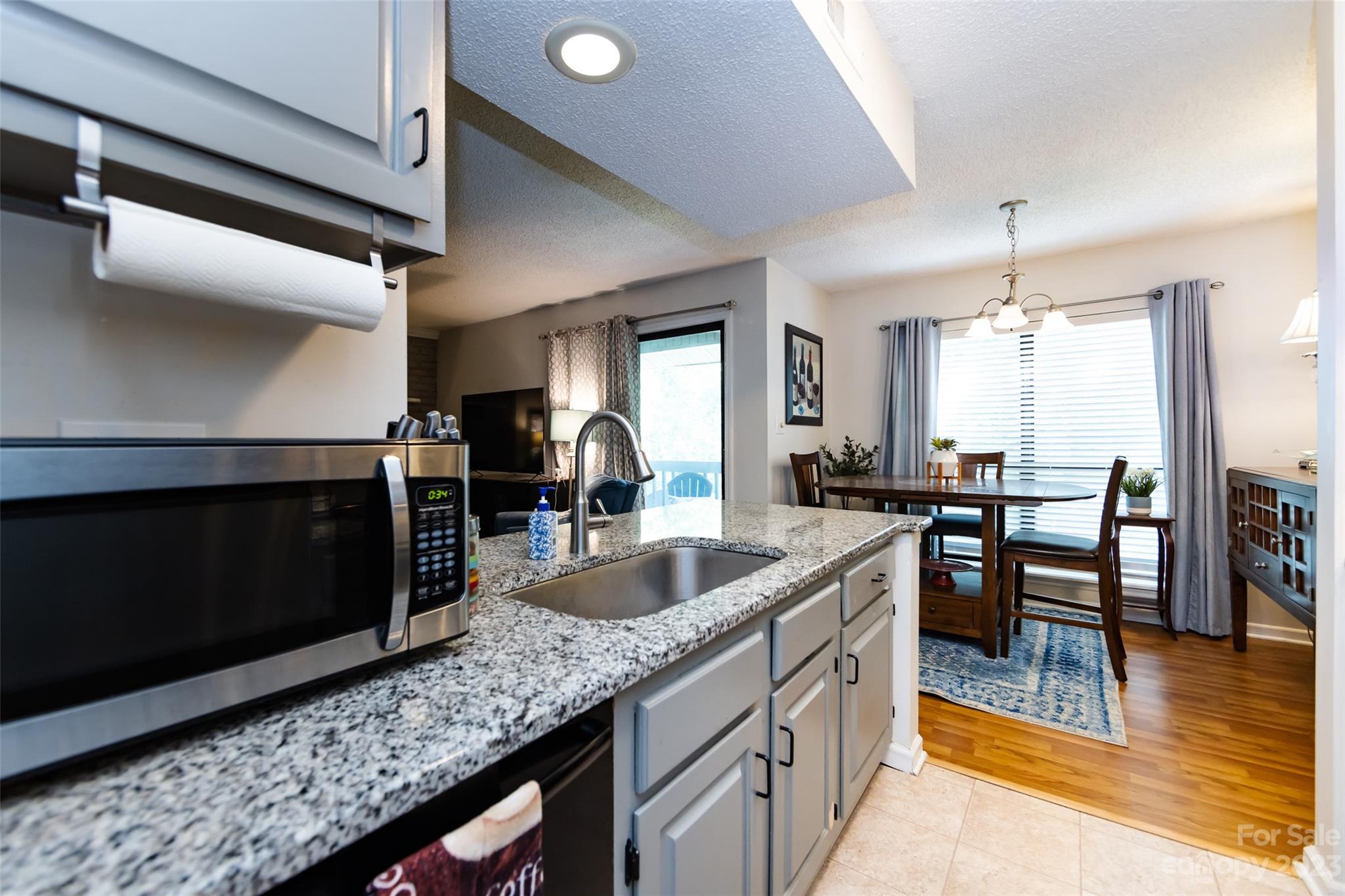 11114 Harrowfield Road Charlotte, NC 28226 - Photo 15 of 25 a kitchen with counter top space and dining table