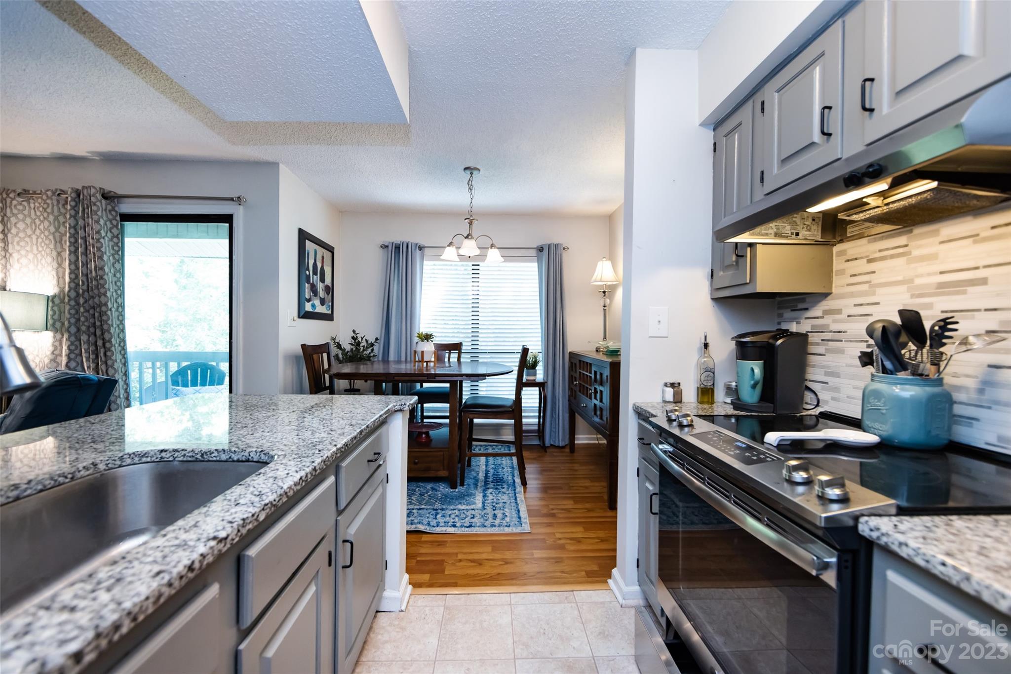 11114 Harrowfield Road Charlotte, NC 28226 - Photo 16 of 25 a kitchen with stainless steel appliances granite countertop a stove a sink and a microwave