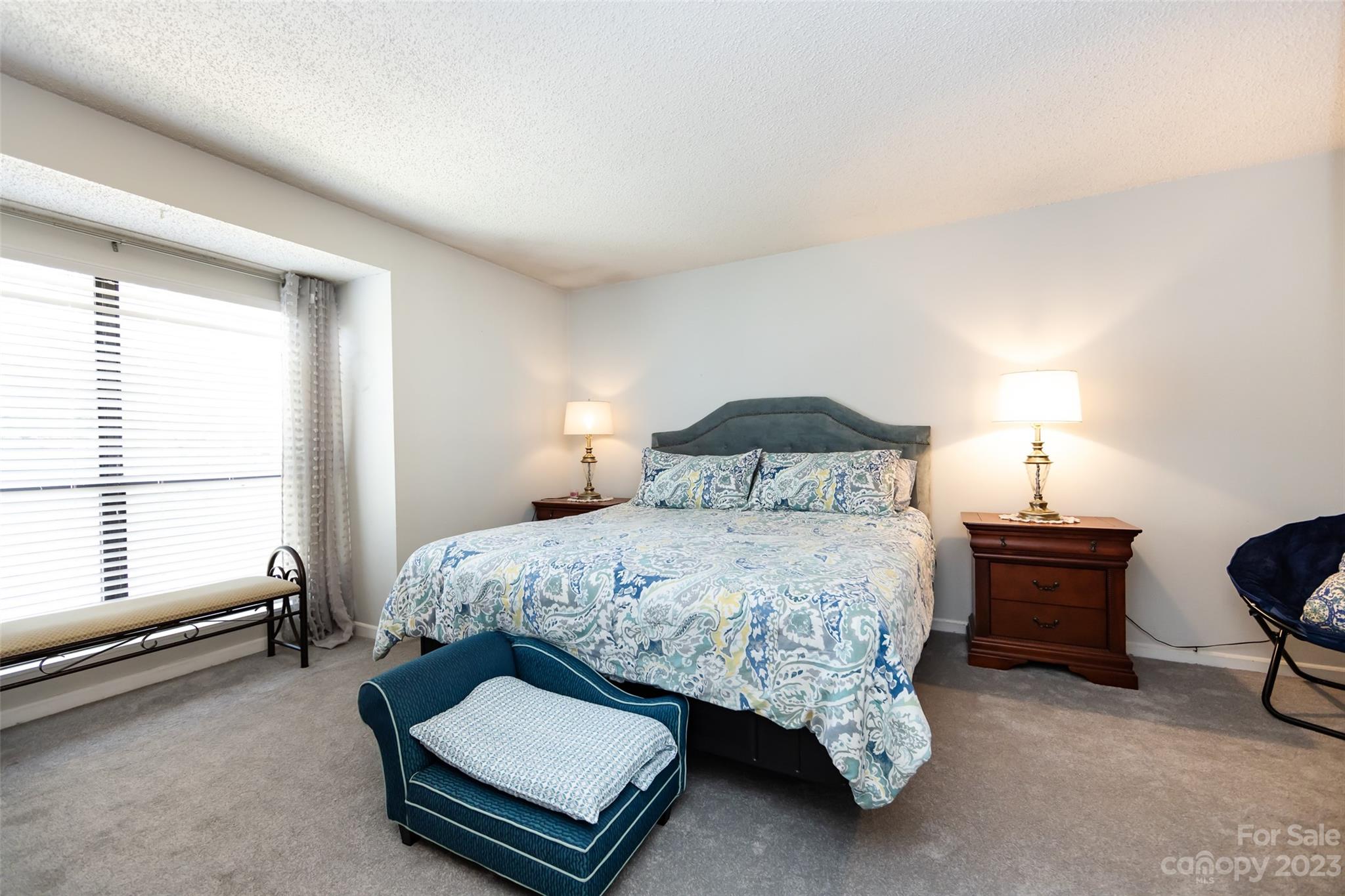 11114 Harrowfield Road Charlotte, NC 28226 - Photo 19 of 25 a bedroom with a bed window and a chair