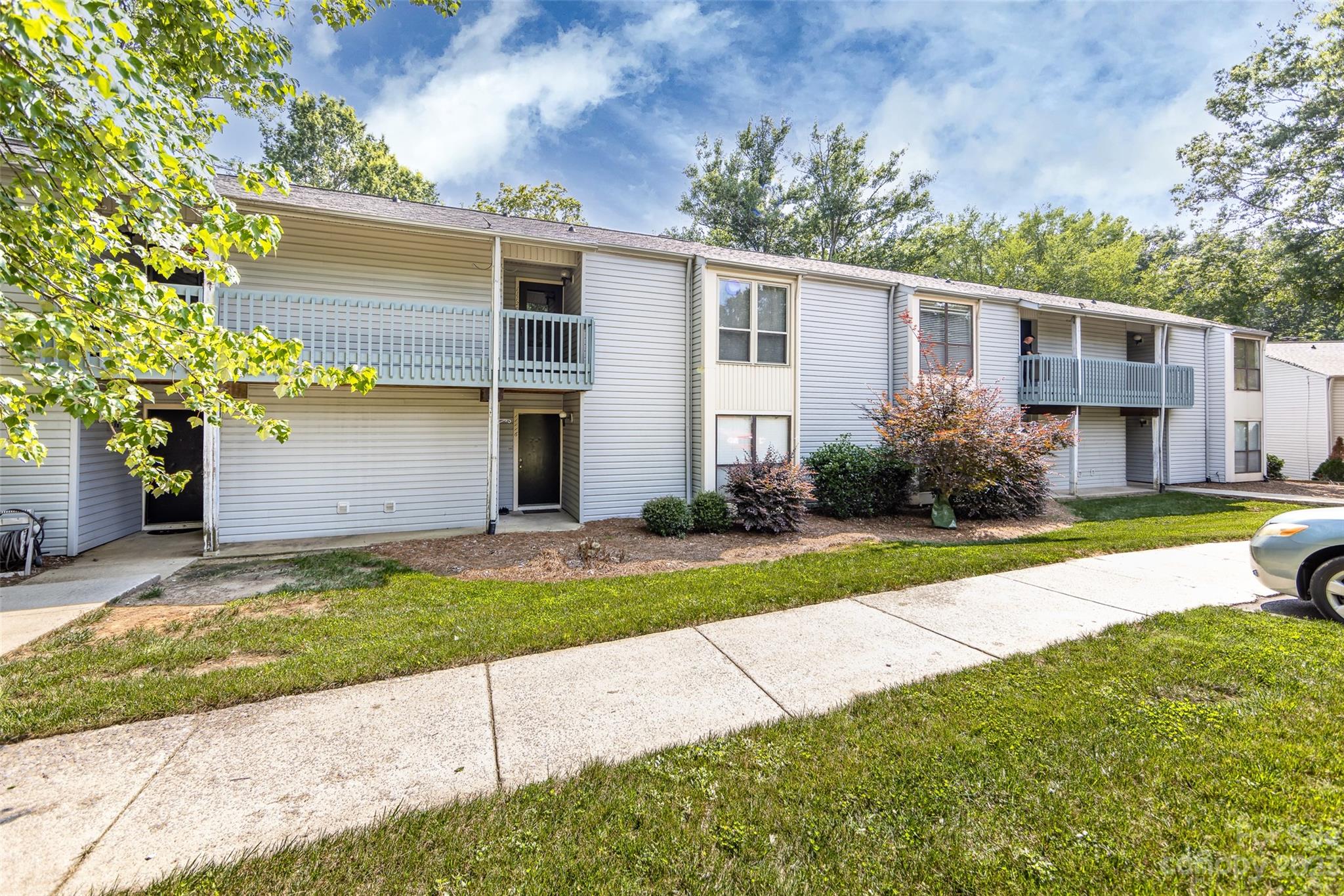 11114 Harrowfield Road Charlotte, NC 28226 - Photo 2 of 25 a front view of a house with a yard and garage