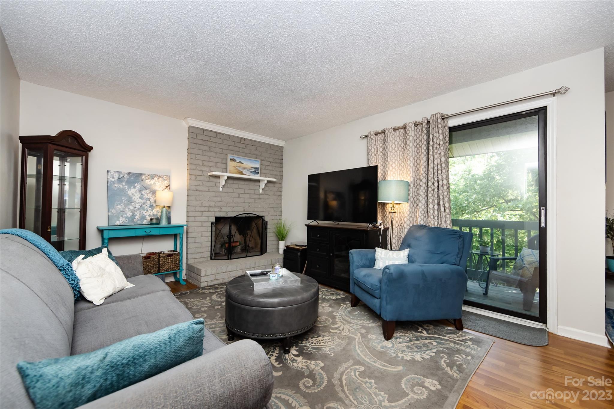 11114 Harrowfield Road Charlotte, NC 28226 - Photo 8 of 25 a living room with furniture a flat screen tv and a fireplace