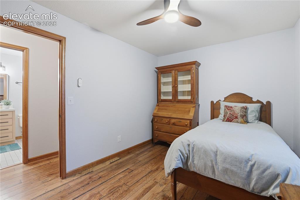 18190 Forest View Road Monument, CO 80132 - Photo 33 of 50 a bedroom with a bed and wooden floor
