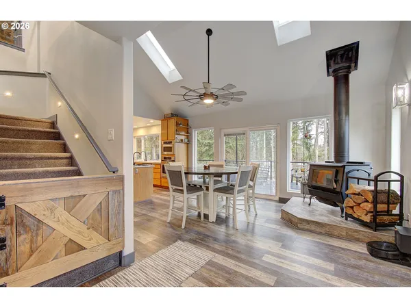 a kitchen with stainless steel appliances granite countertop a sink a stove and a wooden floors