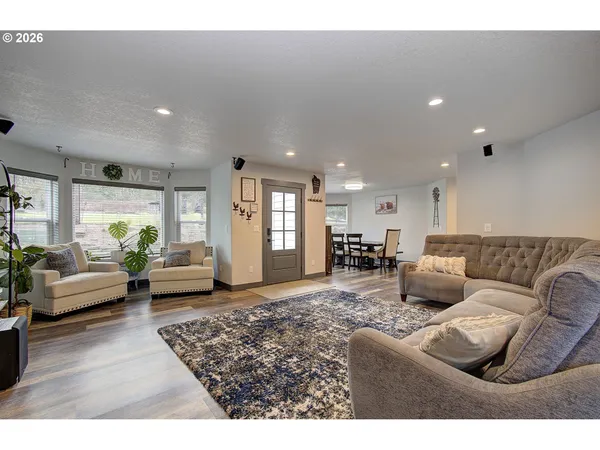 a living room with furniture and kitchen view