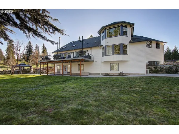 a view of a house with backyard and sitting area