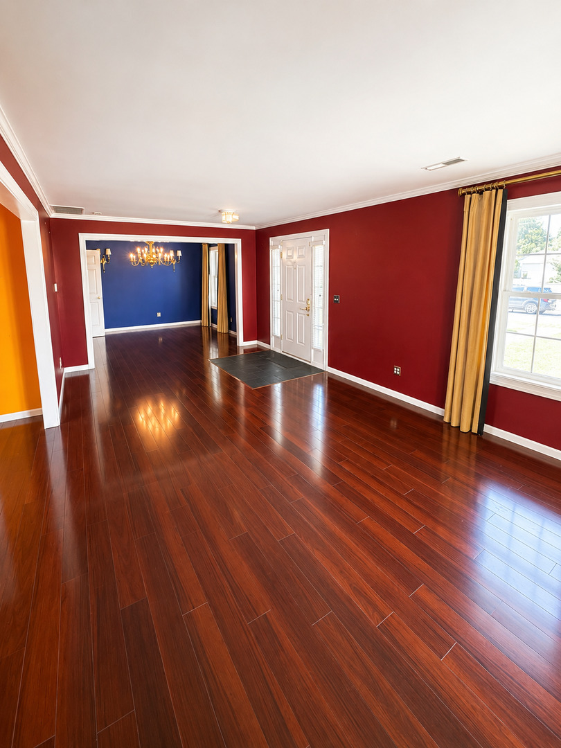 354 19th Place Clinton, IA 52732 - Photo 5 of 16 a view of an empty room with wooden floor and a window