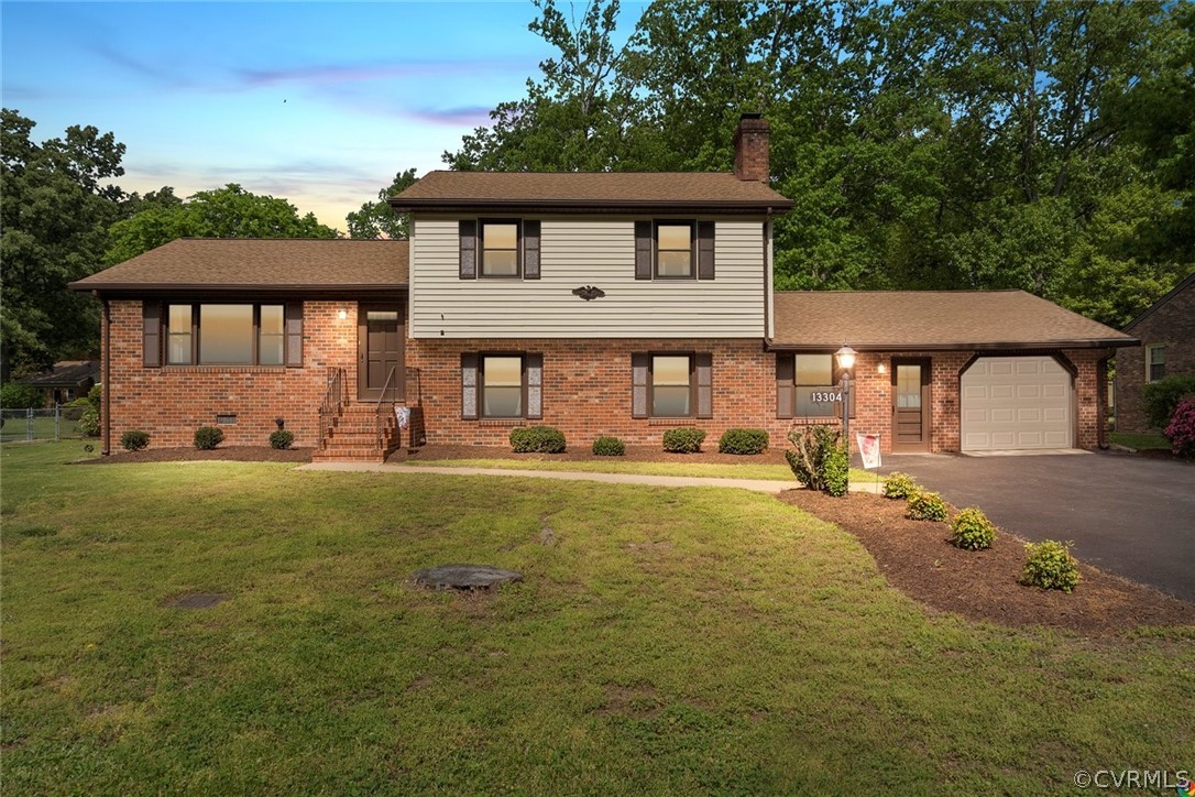 13304 South Chester Road Chester, VA 23831 - Photo 1 of 46 a front view of a house with a yard