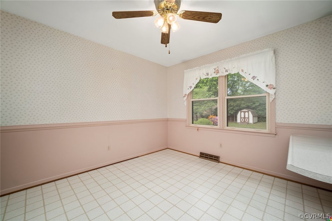 13304 South Chester Road Chester, VA 23831 - Photo 12 of 46 an empty room with windows and chandelier fan