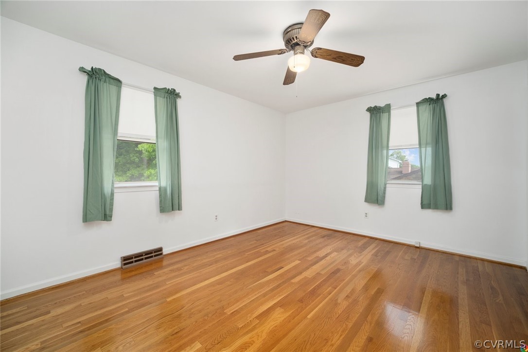 13304 South Chester Road Chester, VA 23831 - Photo 15 of 46 a view of an empty room with window and wooden floor