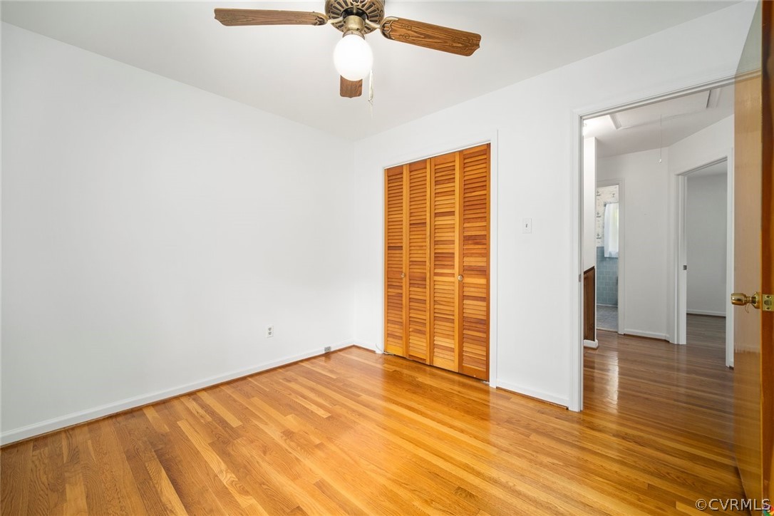 13304 South Chester Road Chester, VA 23831 - Photo 20 of 46 an empty room with wooden floor closet and windows