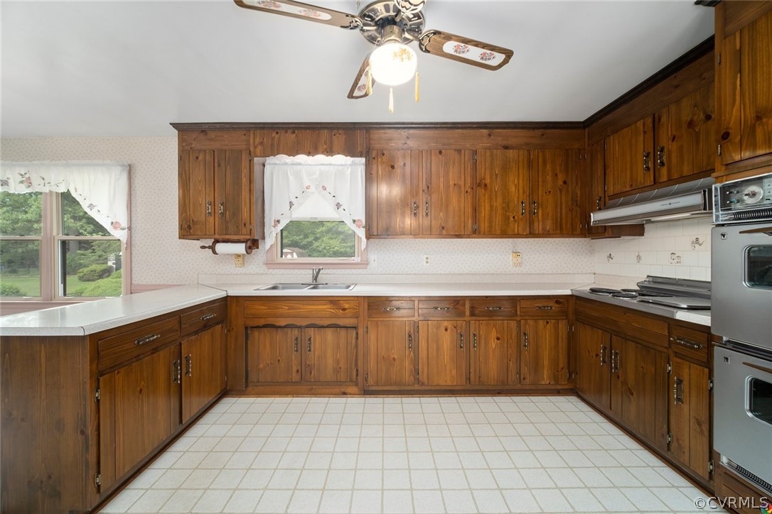 13304 South Chester Road Chester, VA 23831 - Photo 7 of 46 a kitchen with stainless steel appliances granite countertop a sink and dishwasher a stove top oven with wooden floor