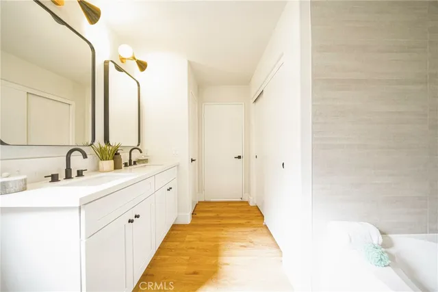 a spacious bathroom with a double vanity sink and a bathtub