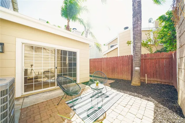 a view of a chair and tables in the patio