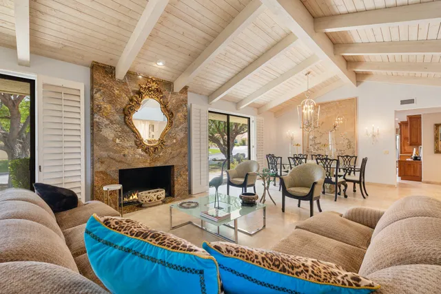 a view of a dining room with furniture and chandelier
