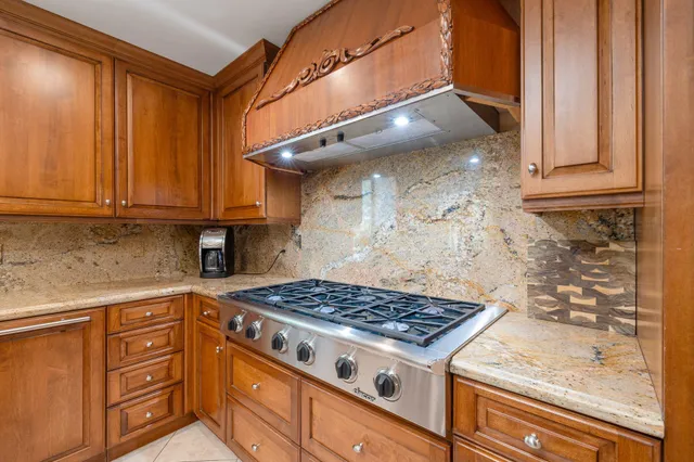 a dining room with furniture and large windows
