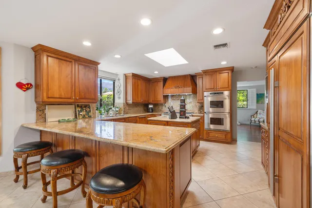 a large kitchen with a table and chairs