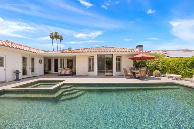a view of a house with a backyard porch and sitting area