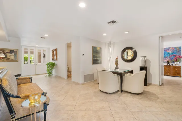 a front view of a house with swimming pool having outdoor seating