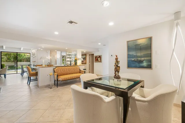 a bedroom with furniture and a large window