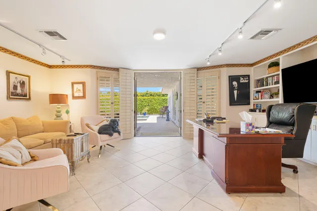 a spacious bedroom with a bed couch and a large window