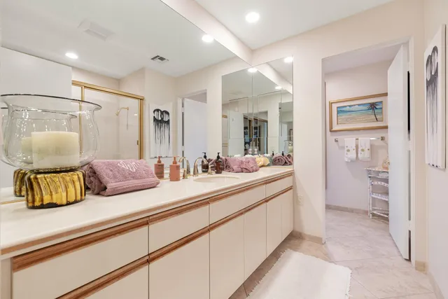 a bedroom with a bed and a flat tv screen on the dresser