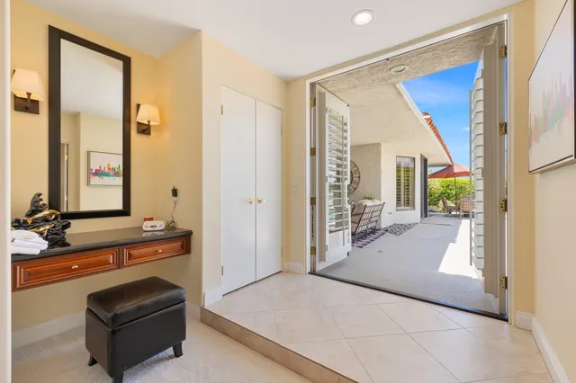 a view of patio with chairs and table under an umbrella