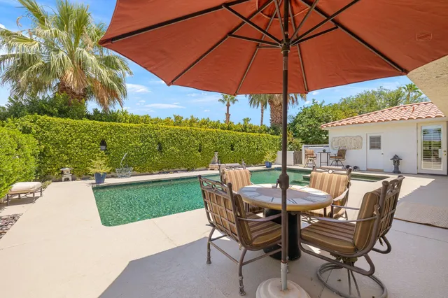 an aerial view of a house with swimming pool garden view and a lake view