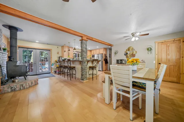 a kitchen with a table chairs stove and cabinets