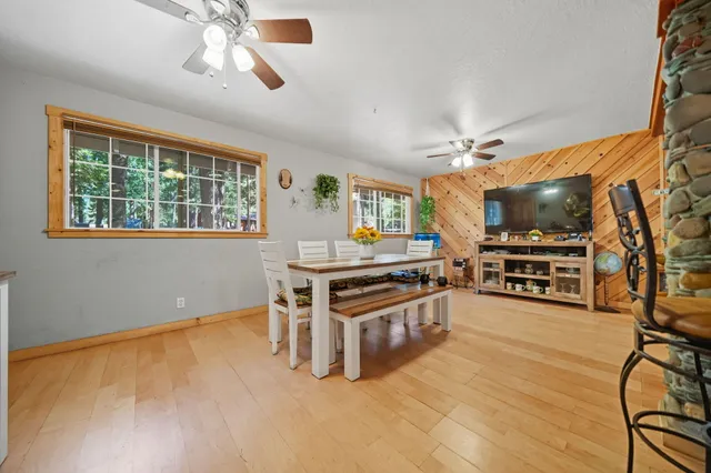 a view of kitchen with stainless steel appliances granite countertop a refrigerator and a stove top oven