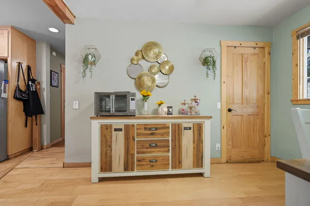 a living room with furniture a flat screen tv and a floor to ceiling window