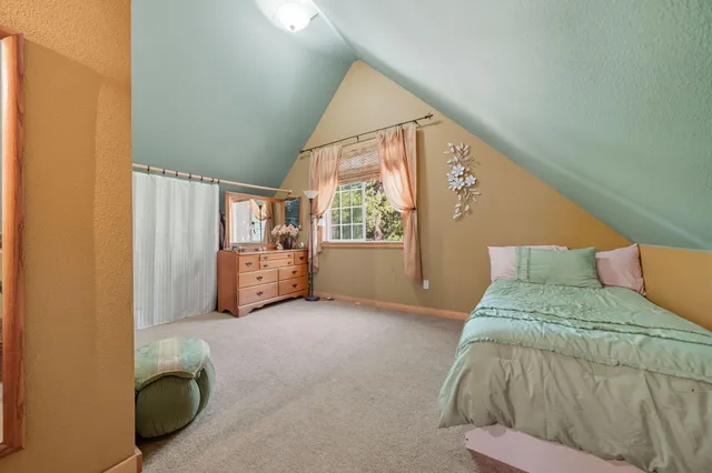 a spacious bedroom with a bed and a window