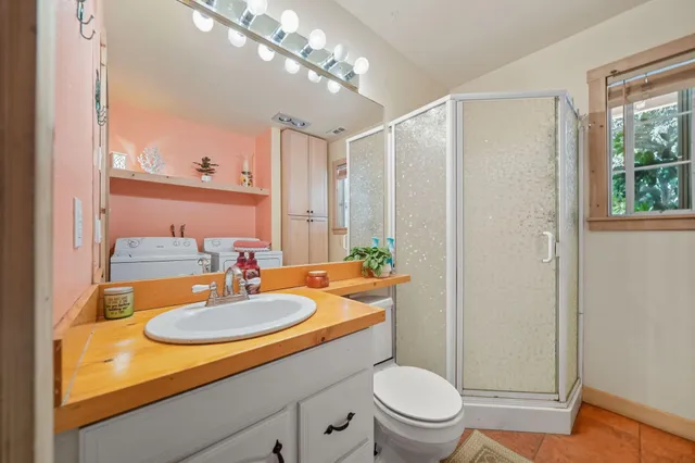 a bathroom with a sink a toilet and shower